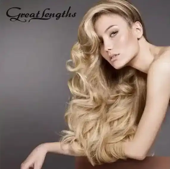 Blonde woman with voluminous long hair showcasing Great Lengths hair extensions.